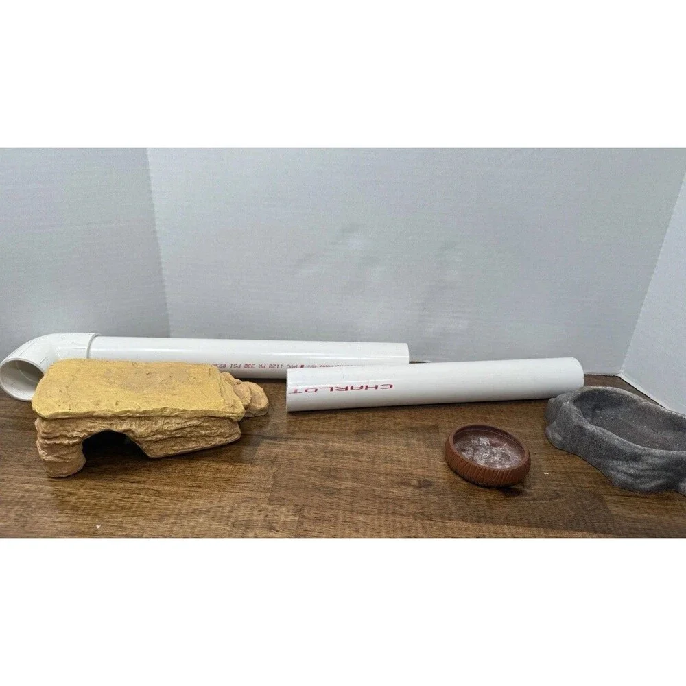 miscellaneous  Reptile supplies, One hide, PVC tubing, Food and water bowl ￼